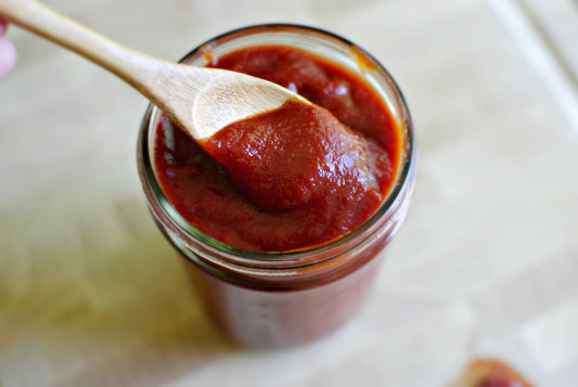 Home Made Ketchup on spoon in jar